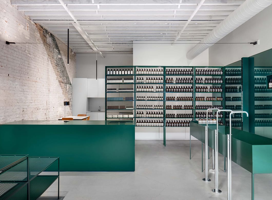 An alternate view of the interior of Aesop West Landing featuring Archetype Glass' custom glass wall cladding