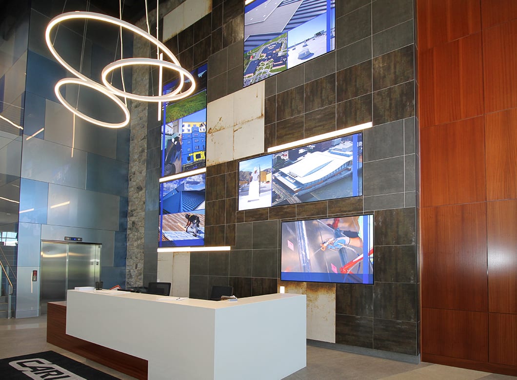 Archetype Glass' custom art glass wall cladding on the reception wall at CCM Training and Education Center