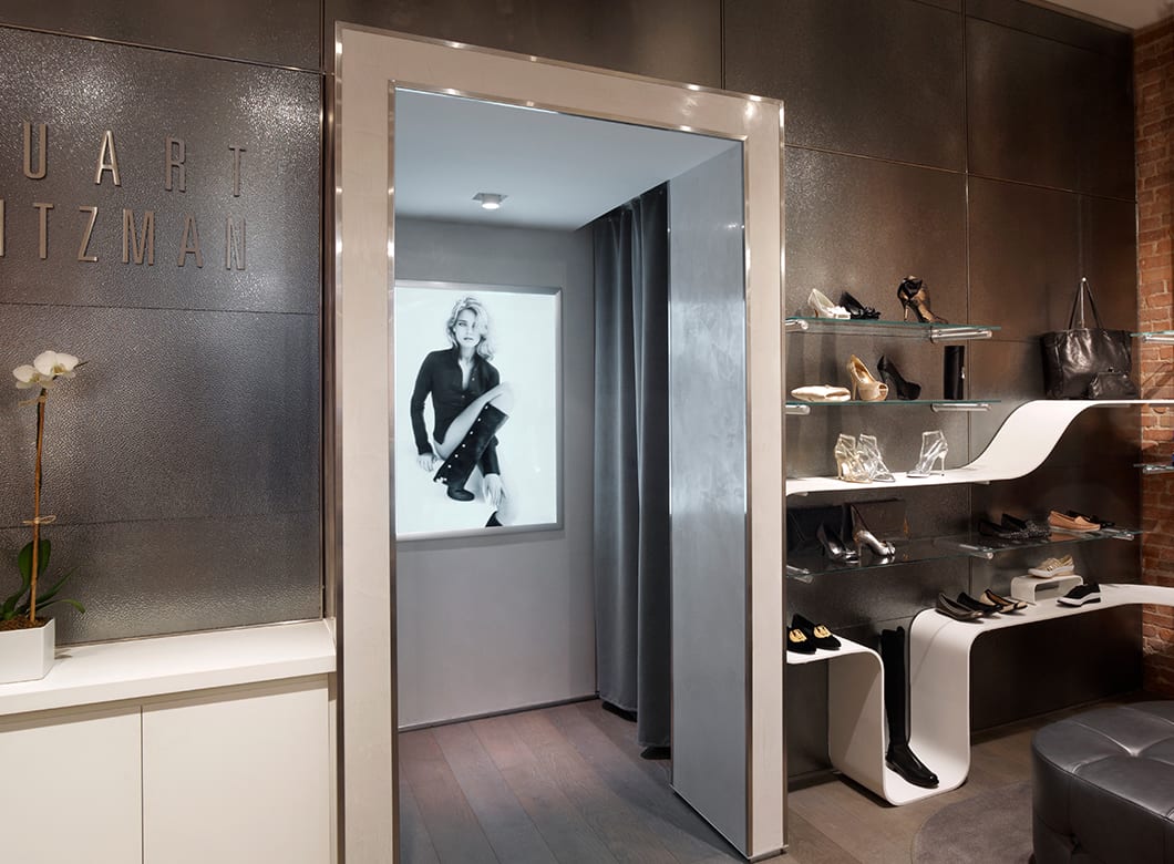 A wide view of the custom art glass wall cladding at Stuart Weitzman Soho, crafted by Archetype Glass