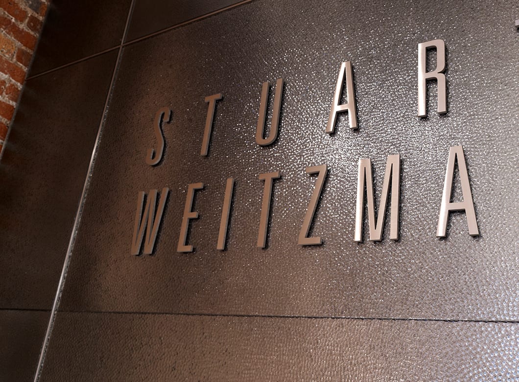 A detailed view of the custom art glass wall cladding at Stuart Weitzman Soho, crafted by Archetype Glass