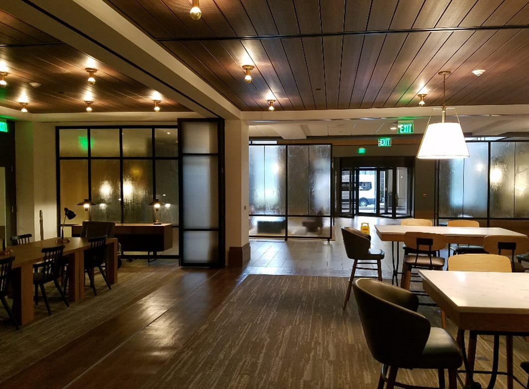 A wide view of the custom laminated art glass partition walls at the Verizon Basking Ridge Hotel Restaurant, by Archetype Glass