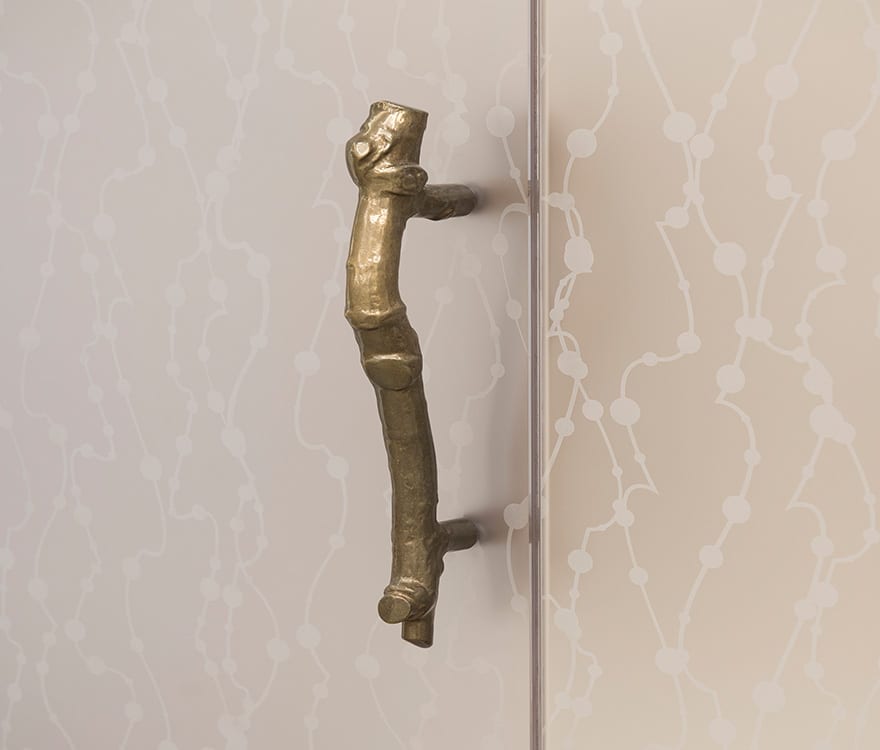 A detailed view of the door handle in the custom glass doors at Hotel Crescent Court's spa, by Archetype Glass