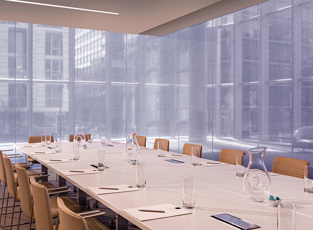 The custom laminated glass partition walls in the Conrad Washington Hotel, crafted by Archetype Glass