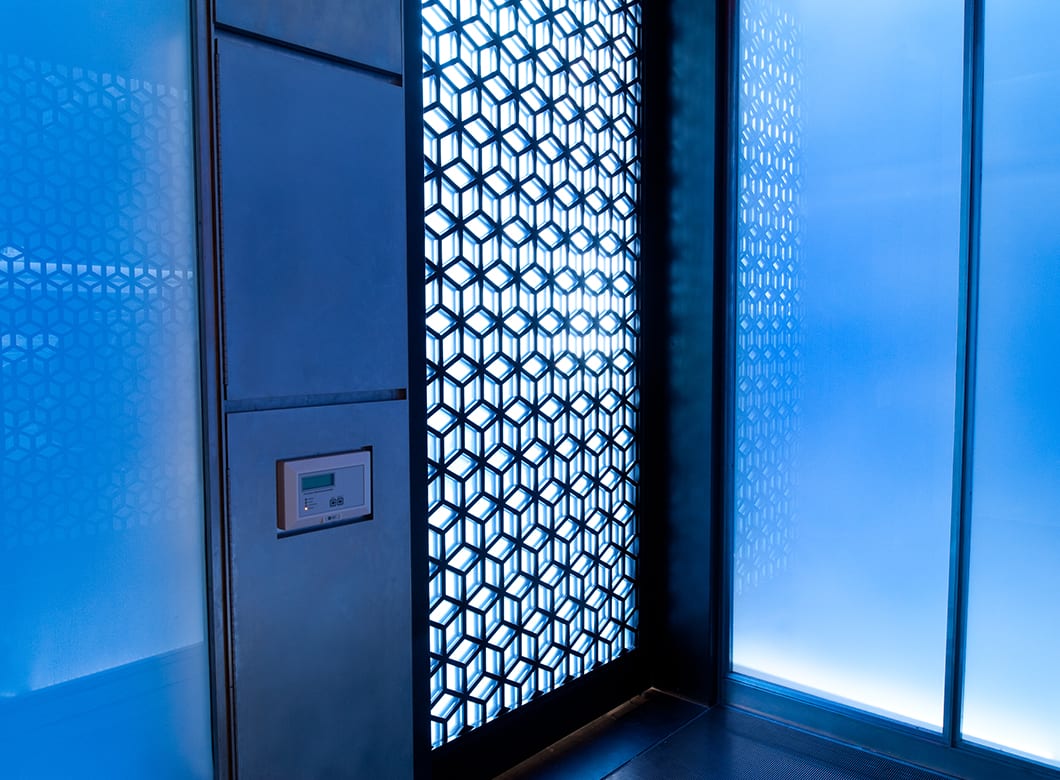 Custom laminated glass wall cladding in the Hakkasan Restaurant, created by Archetype Glass